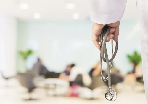 doctor-is-going-examine-his-patient-using-his-stethoscope-sitting-people Doctor is going to examine his patient using his stethoscope over sitting people in modern hospital background